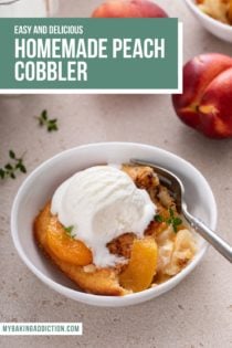White bowl filled with a serving of homemade peach cobbler, topped with ice cream, with a spoon taking a bite of the cobbler. Text overlay includes recipe name.