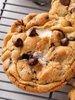 Close up of giant s'mores cookie on a wire rack.