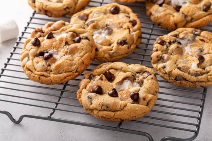 Giant s'mores cookies on a wire cooling rack, ready to be enjoyed.