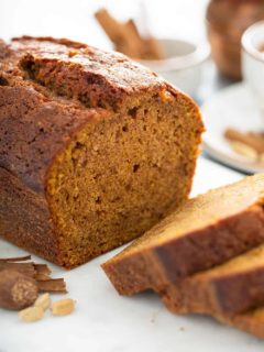 Sliced loaf of butternut squash bread on a cutting board