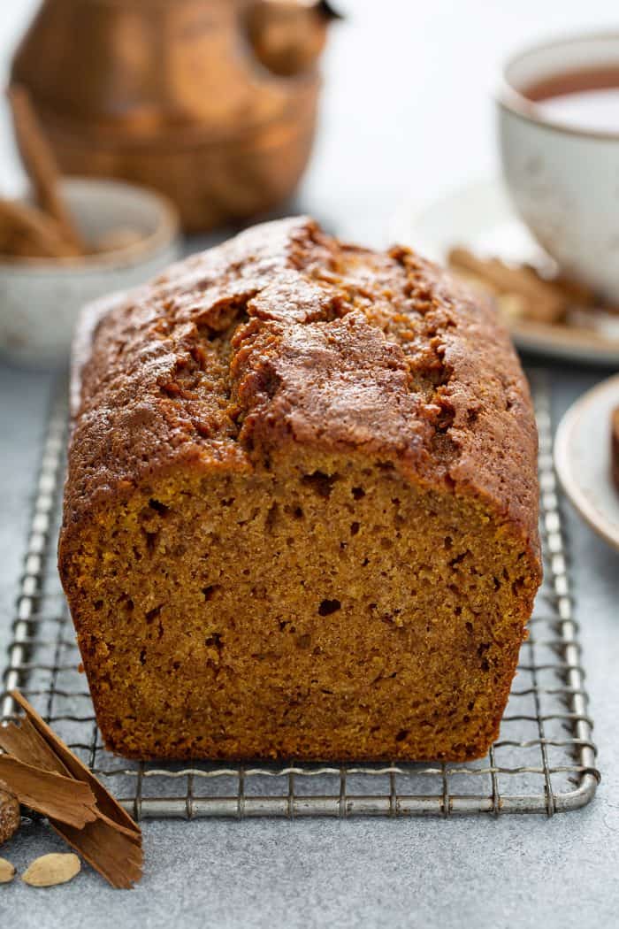 End view of a sliced loaf of butternut squash bread on a metal cooling rack