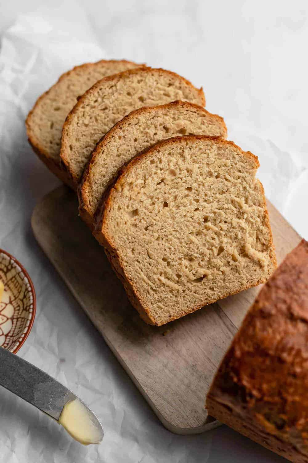 Sliced loaf of beer bread on a wooden cutting board