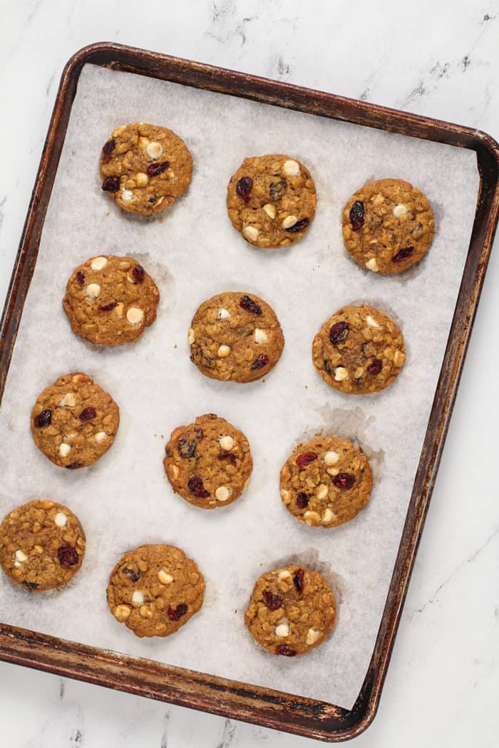 Freshly baked pumpkin oatmeal cookies on a parchment-lined baking sheet