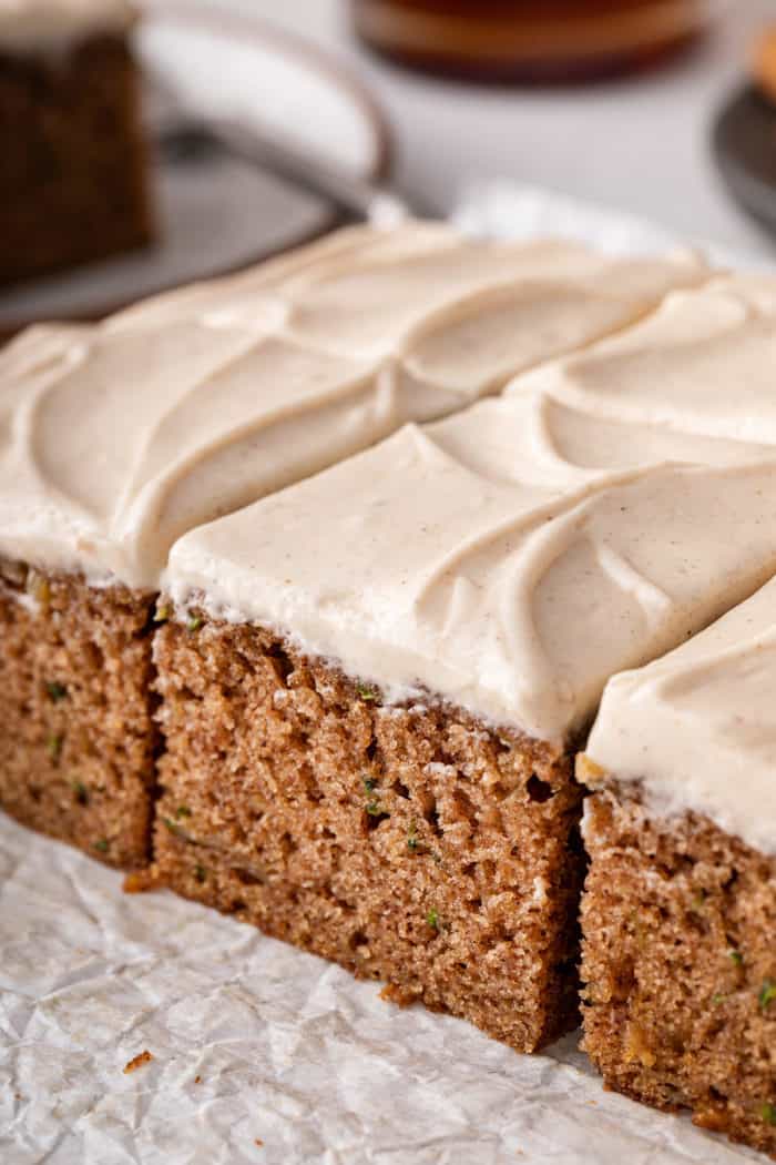 Side view of sliced zucchini cake with maple cream cheese frosting.