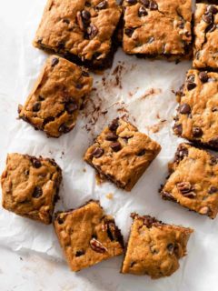 Sliced pumpkin blondies with chocolate chips on parchment paper