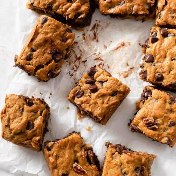 Sliced pumpkin blondies with chocolate chips on parchment paper