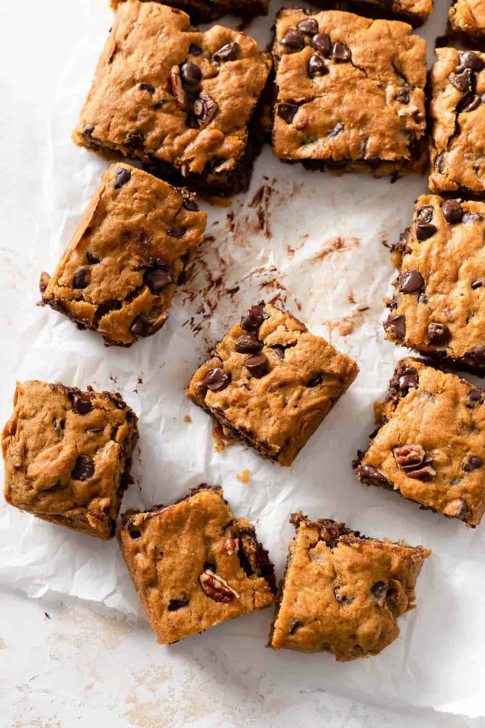 Sliced pumpkin blondies with chocolate chips on parchment paper