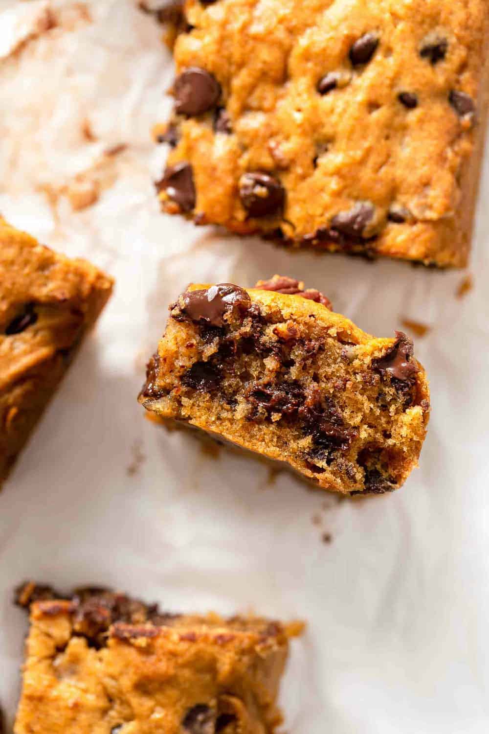 Side view of a sliced pumpkin blondie with gooey chocolate chips