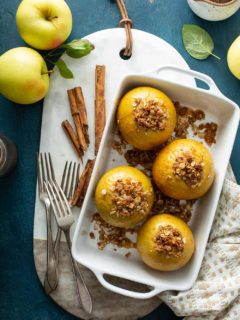 Overhead view of baked apples in a white baking dish