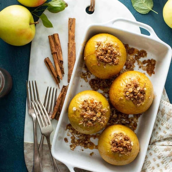 Overhead view of baked apples in a white baking dish