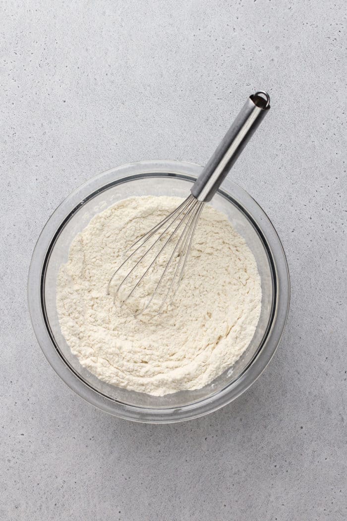 Dry ingredients for brown butter blondies whisked together in a glass mixing bowl.