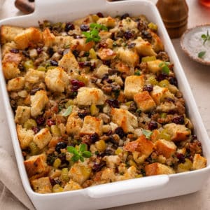 Sausage and cranberry stuffing in a white baking dish.