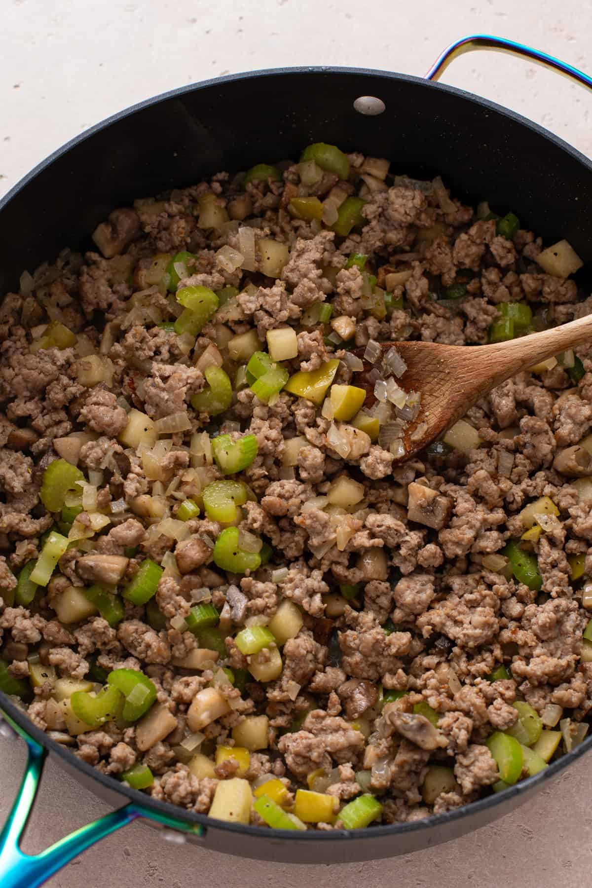Cooked sausage and vegetables for stuffing in a skillet.