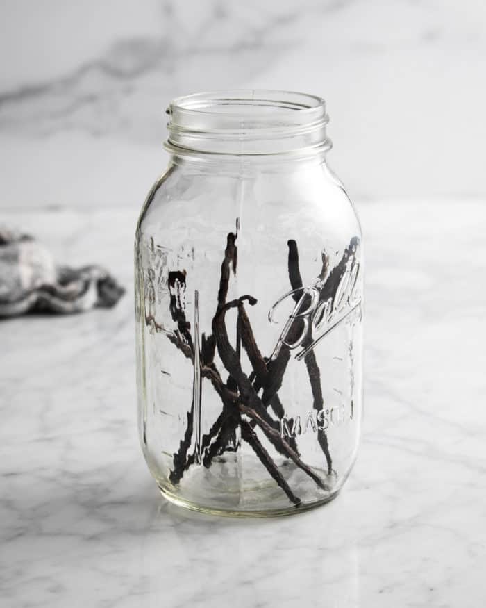 Vanilla beans in a large glass mason jar.