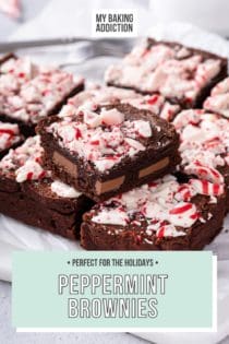 Sliced pan of peppermint brownies. One of the brownies is set on top of the rest to show the milk chocolate pieces in the center. Text overlay includes recipe name.