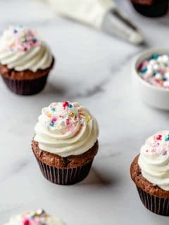 Cupcake with homemade buttercream frosting and multicolored sprinkles
