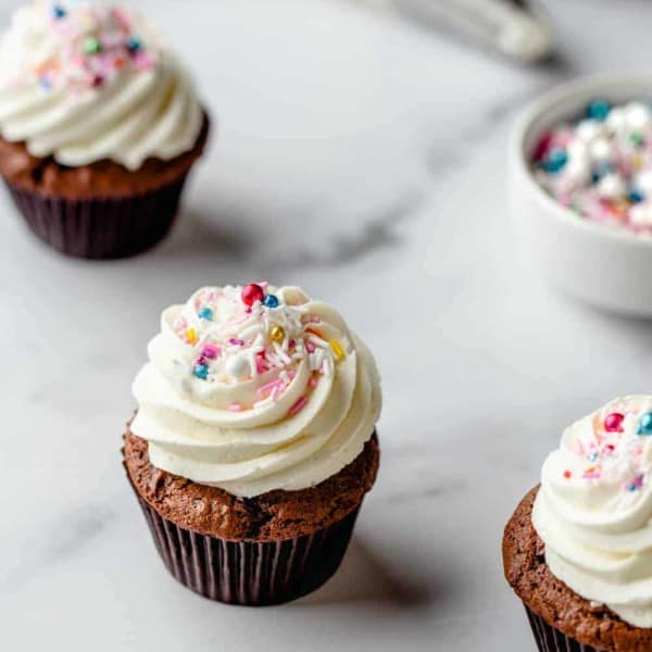 Cupcake with homemade buttercream frosting and multicolored sprinkles