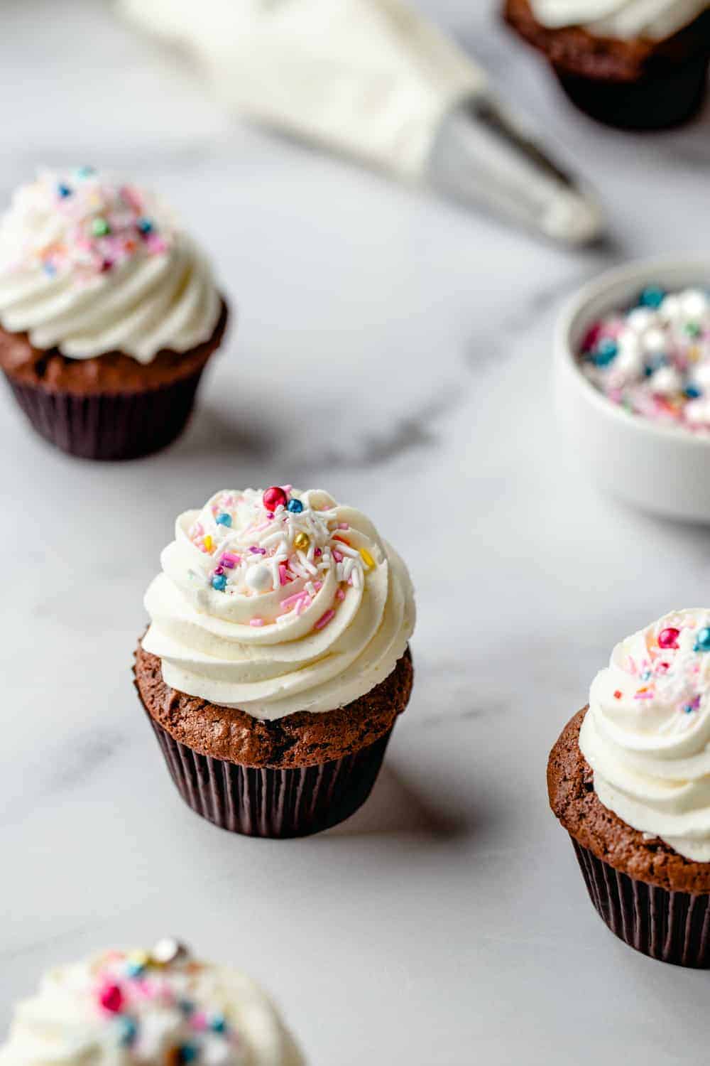 Cupcake with homemade buttercream frosting and multicolored sprinkles