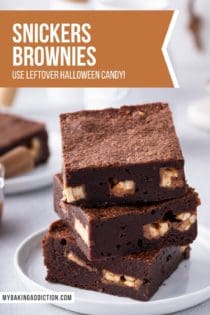 Three snickers brownies stacked on a white plate. Text overlay includes recipe name.