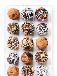 Overhead shot of homemade truffles in a variety of toppings on a plate