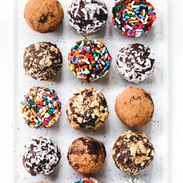 Overhead shot of homemade truffles in a variety of toppings on a plate