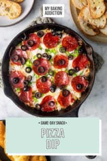 Baked pizza dip in a cast iron skillet, surrounded by bowls of crostini and breadsticks. Text overlay includes recipe name.