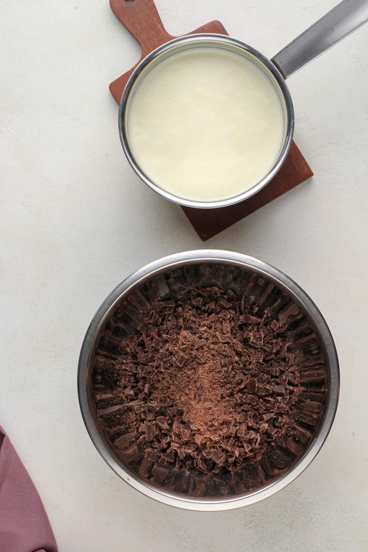 Chocolate ganache ingredients on a beige countertop.