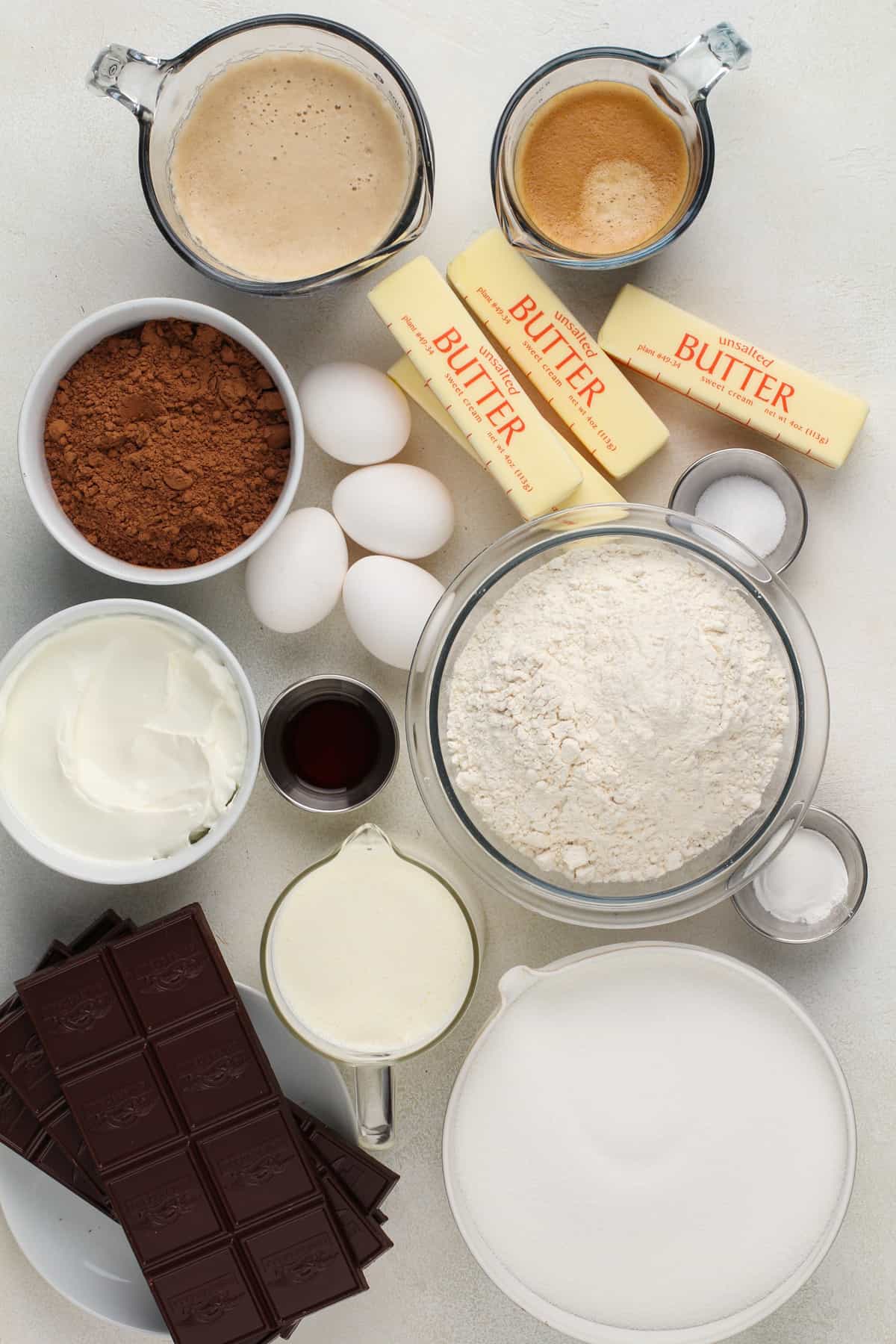 Ingredients for chocolate guinness cake arranged on a beige countertop.