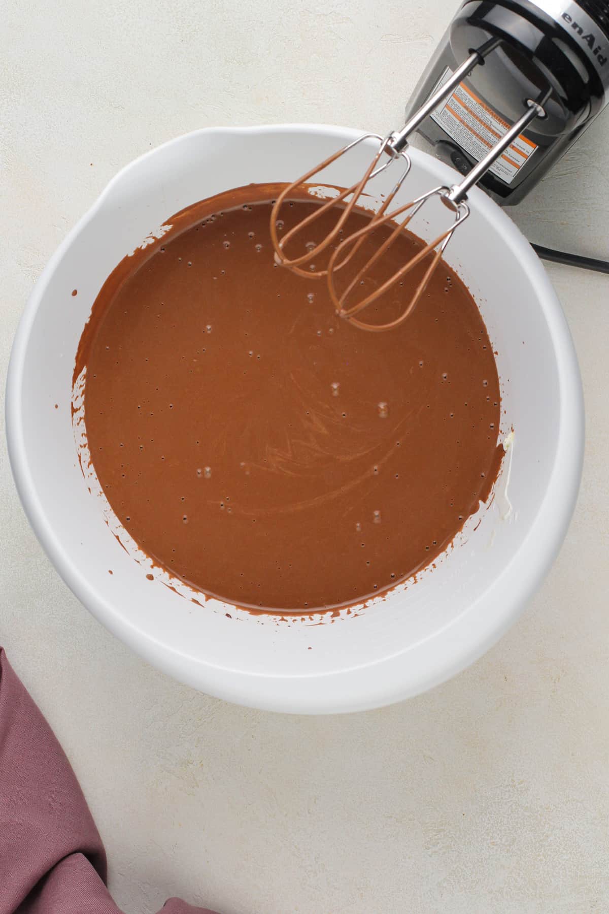Wet ingredients for chocolate guinness cake in a white bowl.