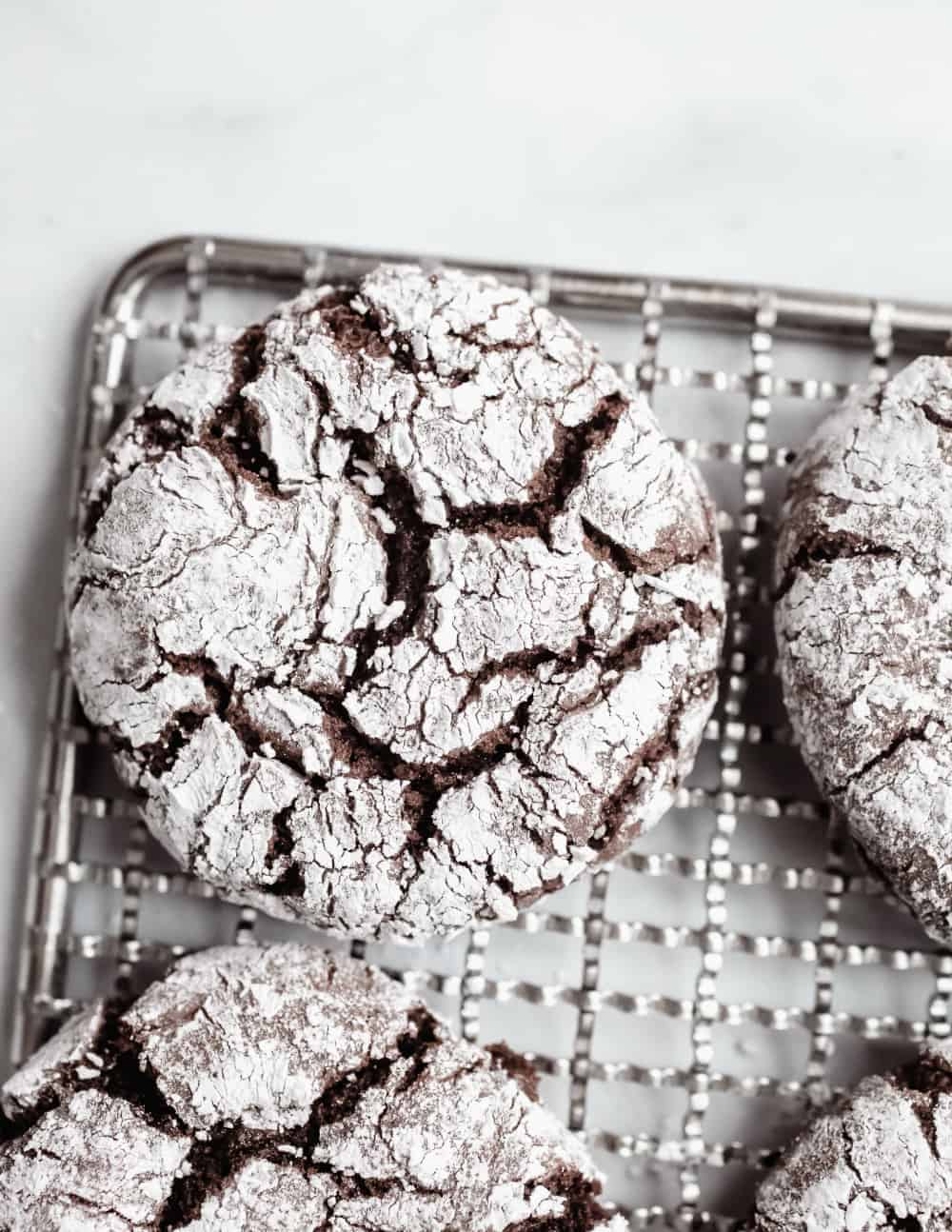 Chocolate crinkle cookies on a wire cooling rack