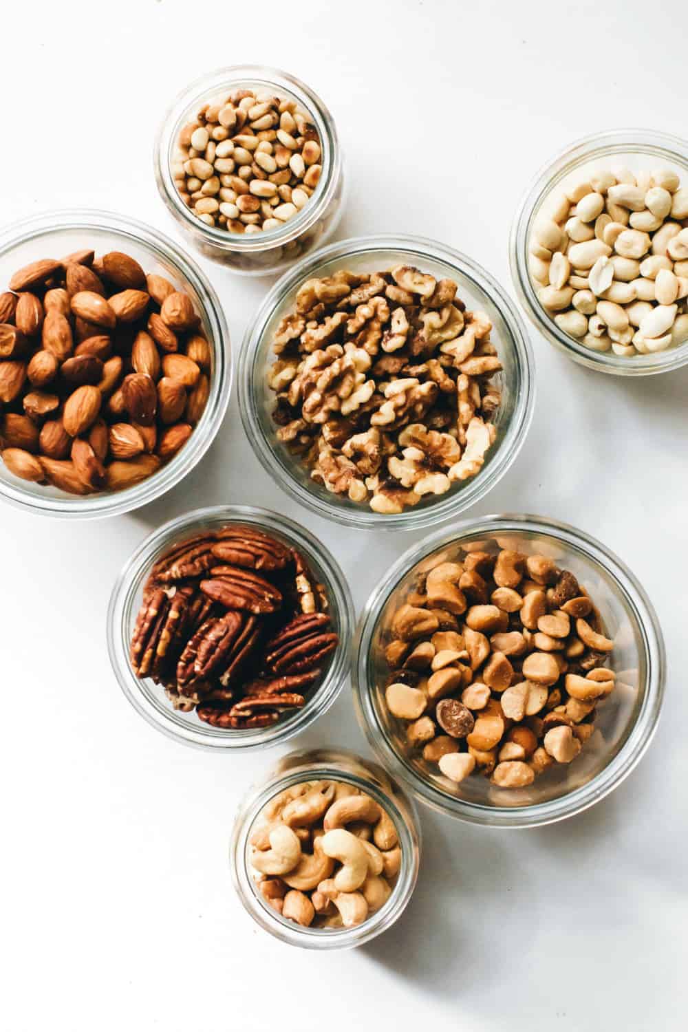 Assorted toasted nuts in glass jars