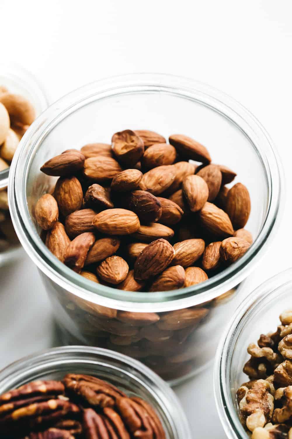 Toasted whole almonds in a glass jar