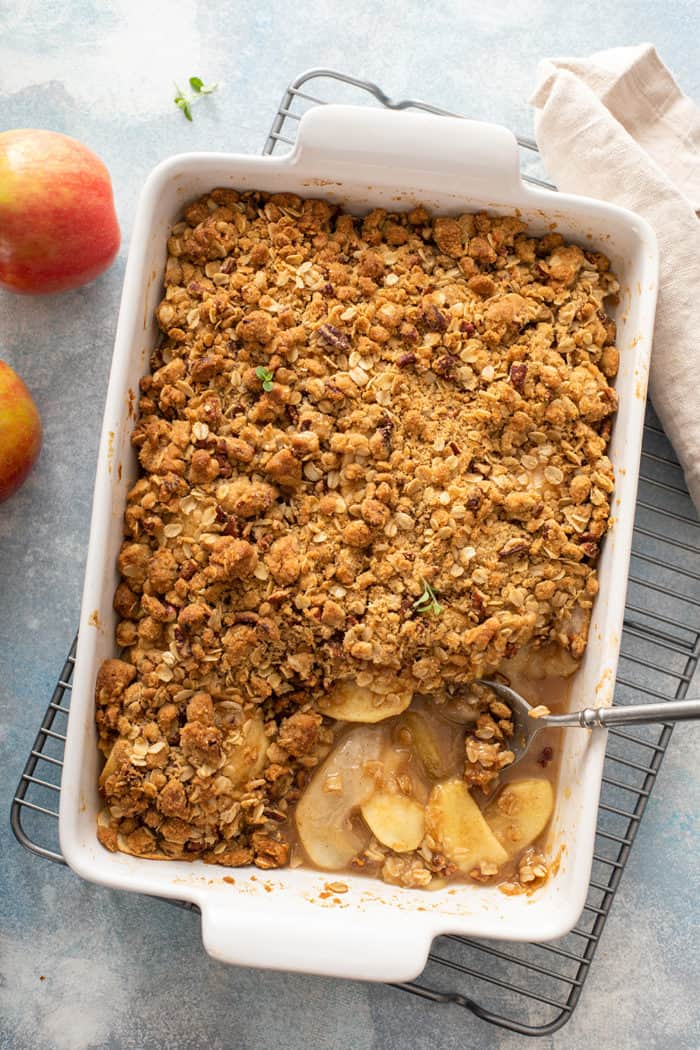 Overhead view of baked apple pear crisp with a spoonful taken out of it