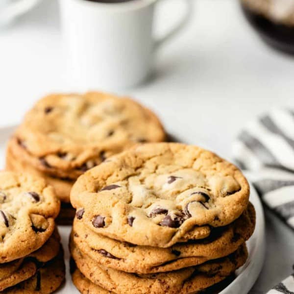 Stack of chocolate chip cookies on a white plate
