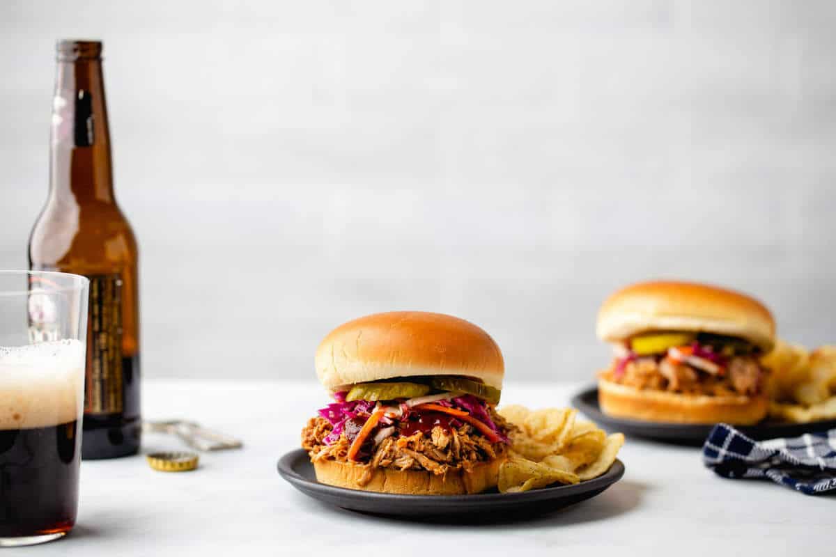 Easy Crockpot Pulled Pork is a game day meal everyone will love. Serve with slaw and pickles for the perfect sandwich.