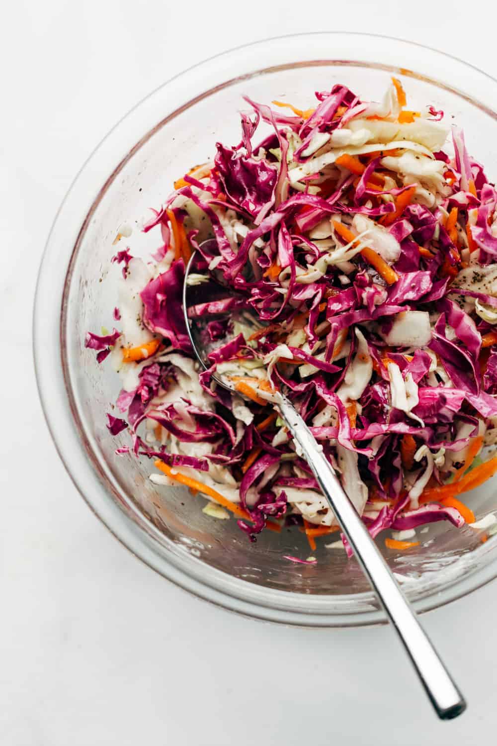 Top Easy Crockpot Pulled Pork with crunchy slaw and serve it on a a slider bun for an easy and delicious dinner.