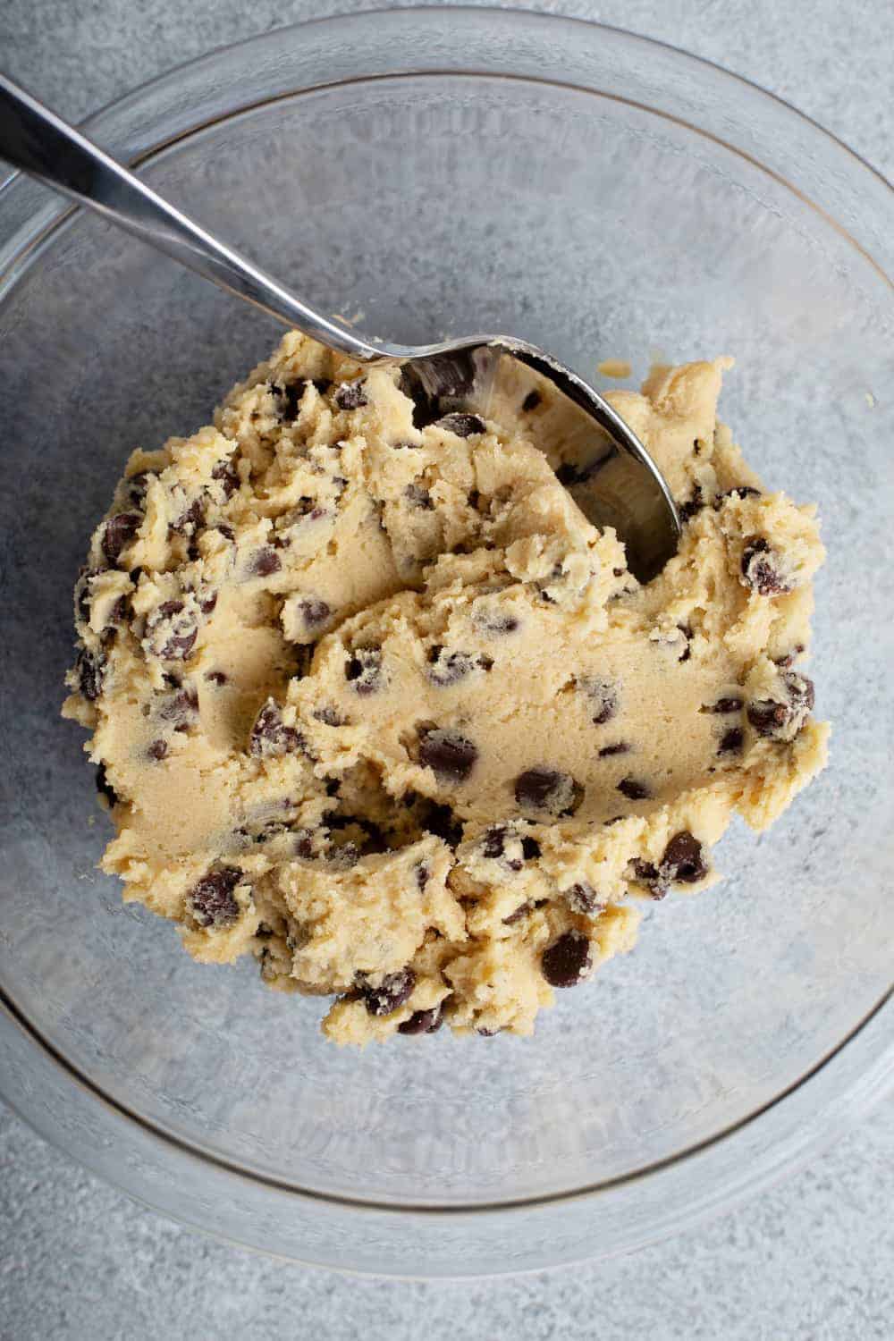 Cookie dough for cheesecake bars in a glass bowl 