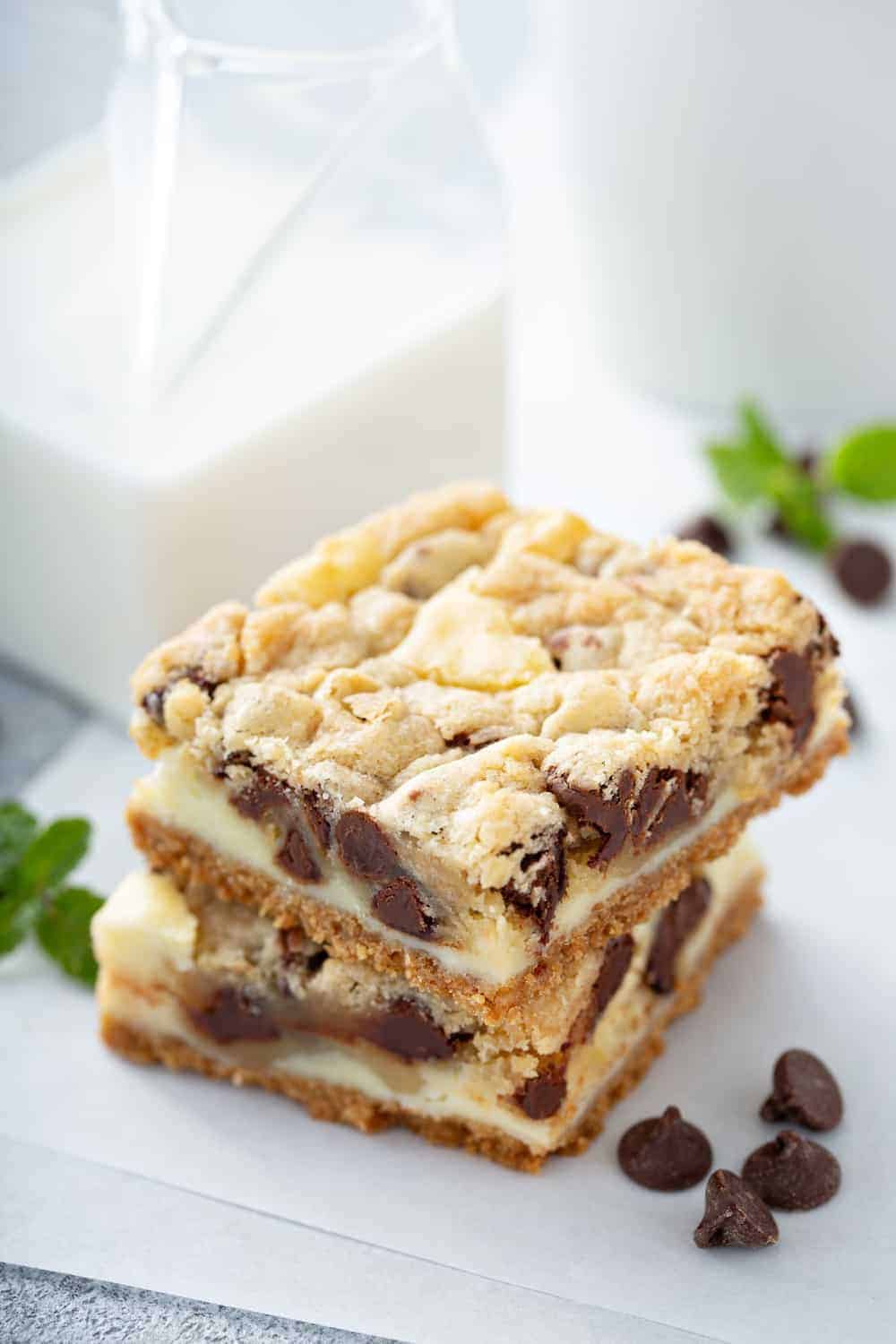 Close up of sliced cookie dough cheesecake bars on a piece of parchment paper