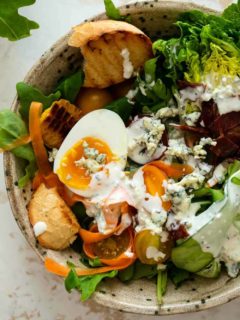 Close up of a salad dressed with blue cheese dressing