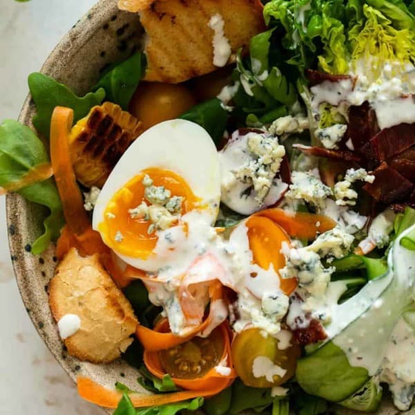 Close up of a salad dressed with blue cheese dressing