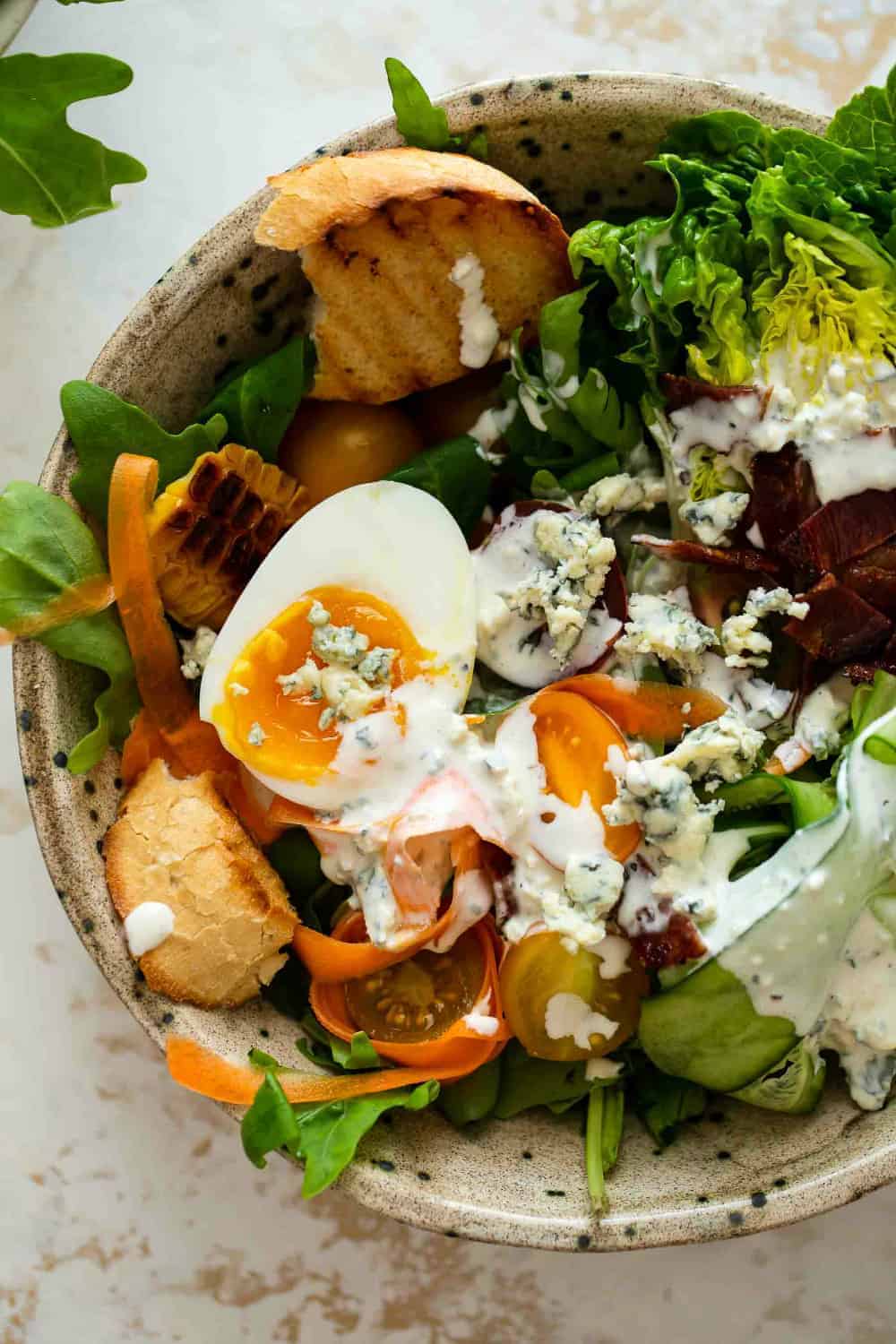 Close up of a salad dressed with blue cheese dressing