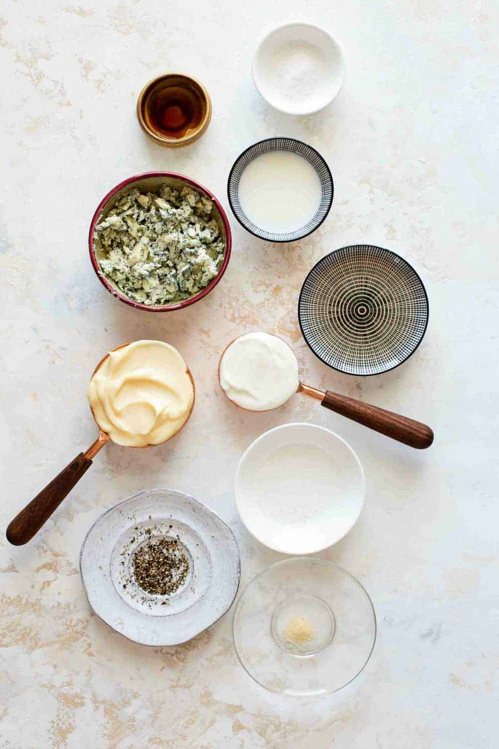 Ingredients for homemade blue cheese dressing in bowls, ready to mix