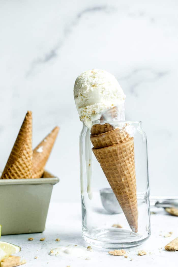 Key lime pie ice cream in a sugar cone propped up in a glass jar