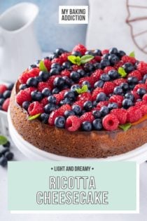 Ricotta cheesecake topped with rows of red and blue berries. Text overlay includes recipe name.