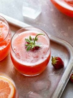 Glass of homemade strawberry lemonade garnished with a strawberry