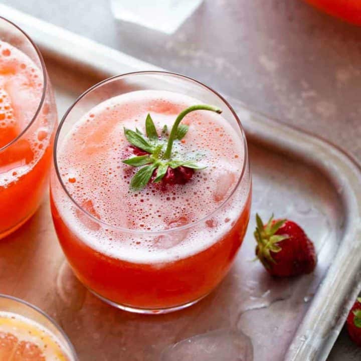 Glass of homemade strawberry lemonade garnished with a strawberry