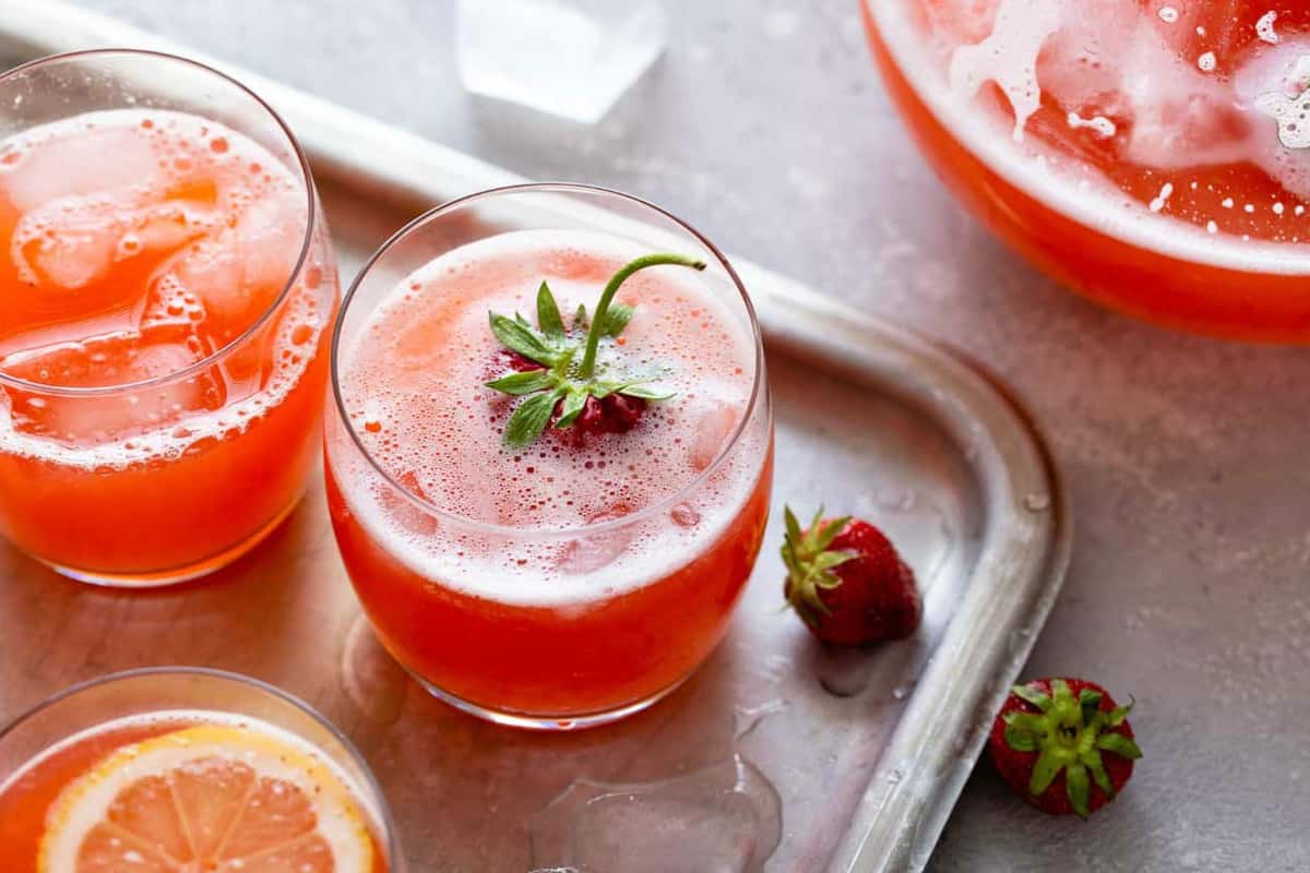 Glasses of strawberry lemonade on a sheet tray