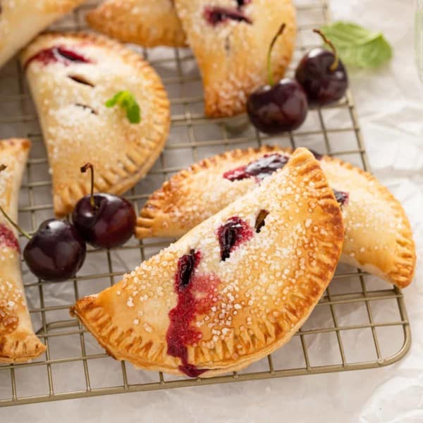 Close up of cherry hand pies cooling on a wire rack