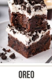 Two oreo brownies stacked on a white plate. A bite has been taken out of the corner of the top brownie. Text overlay includes recipe name.