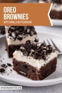 Close up of two oreo brownies topped with frosting and chopped oreos on a white plate. Text overlay includes recipe name.